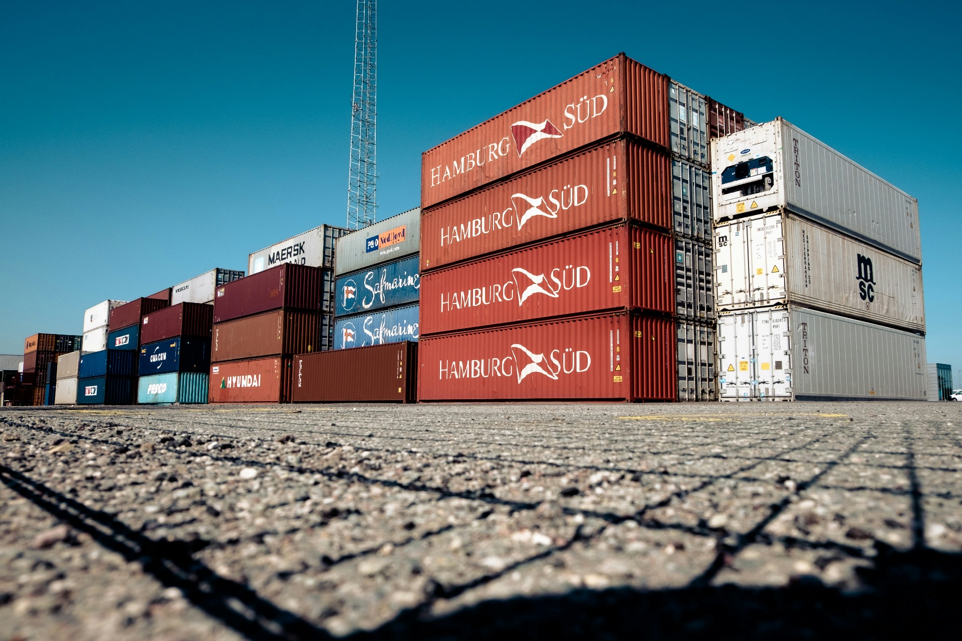 Stacked shipping containers on a compacted industrial storage yard